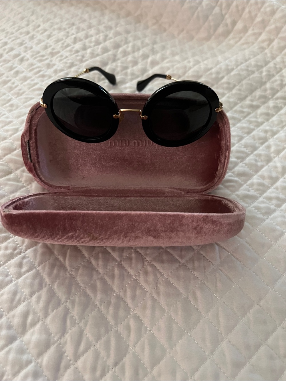 Miu Miu. Classic Black Round Sunglasses with Gold Accents with the case.